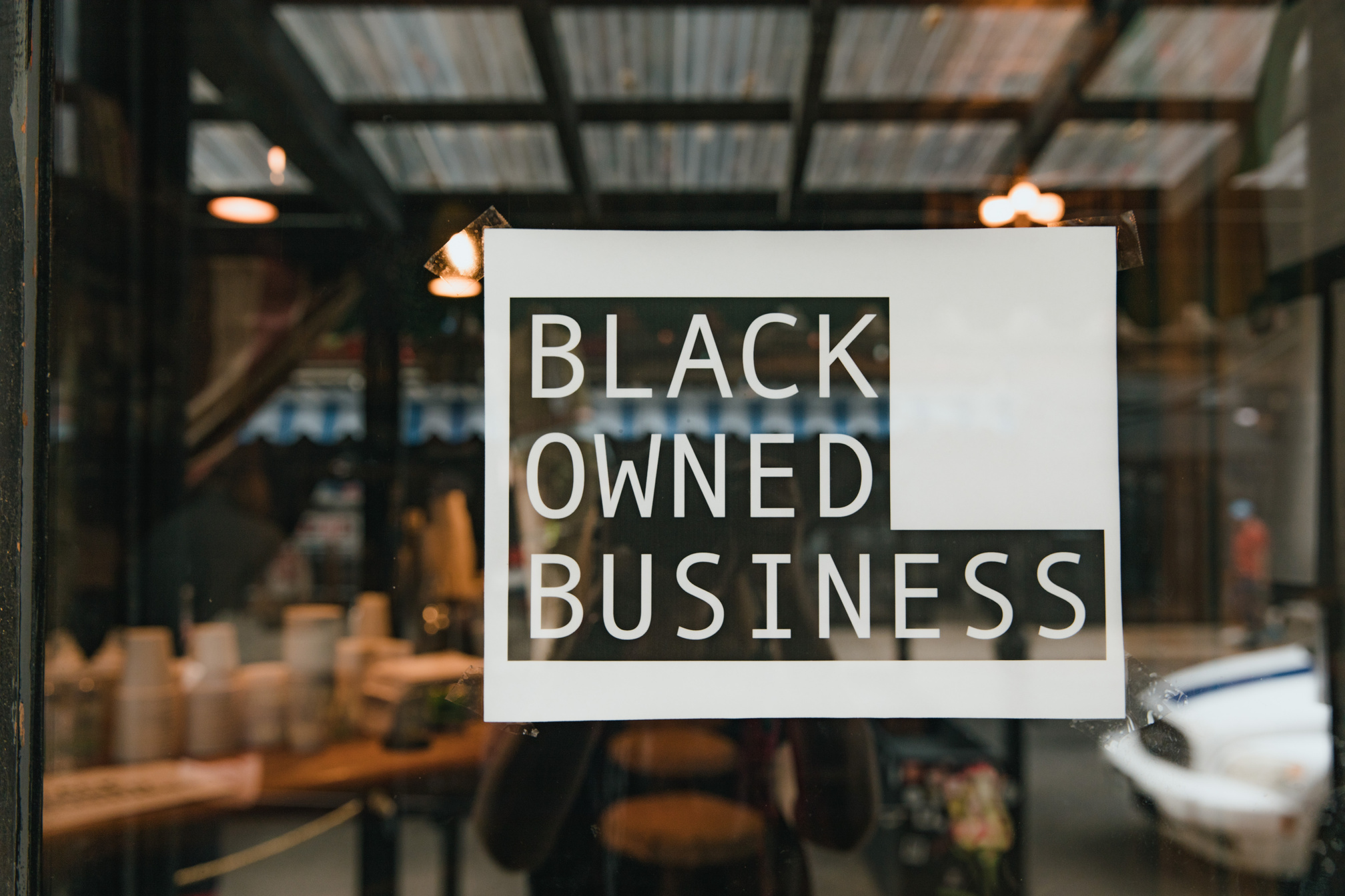 Store Window with Black Owned Business Sign